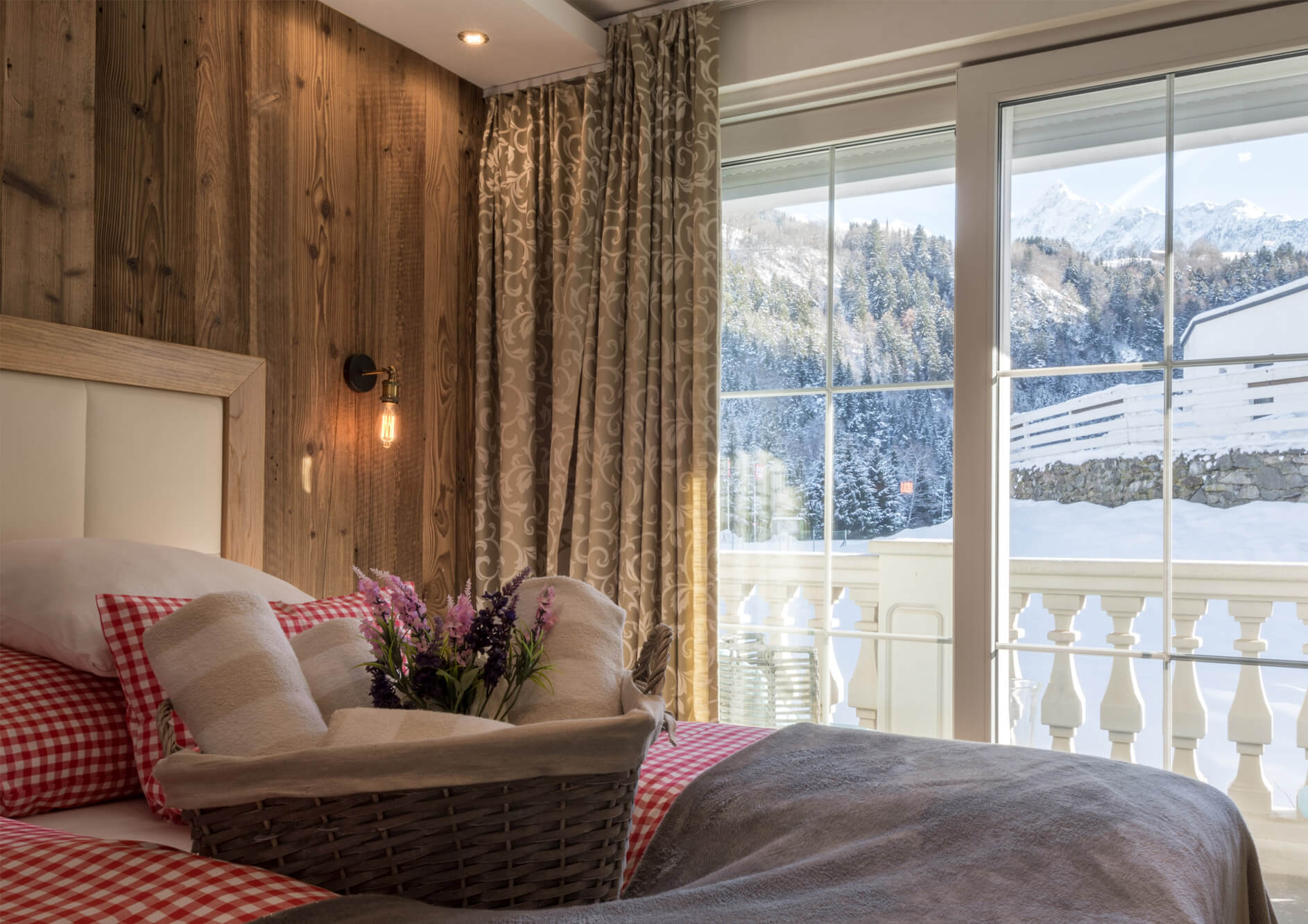 Doppelbett mit karierter Bettwäsche im Deluxe Zimmer